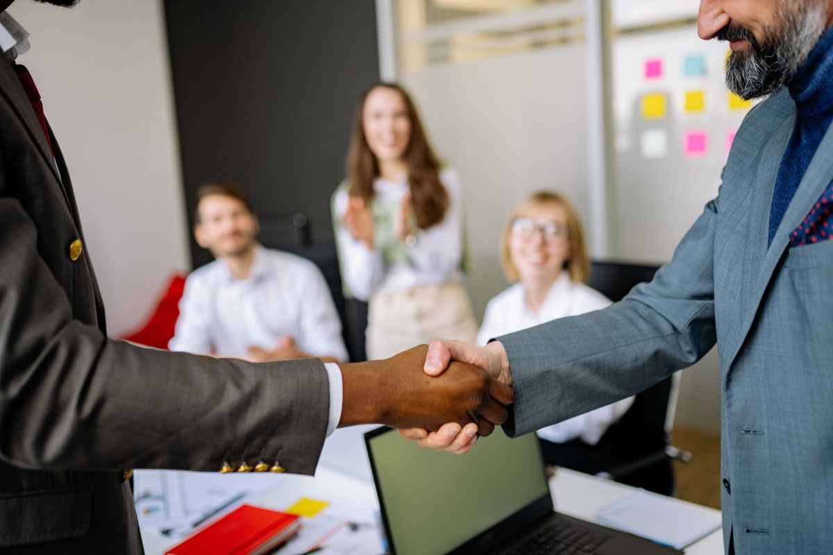 Business owner shaking hands with a new service provider in an office